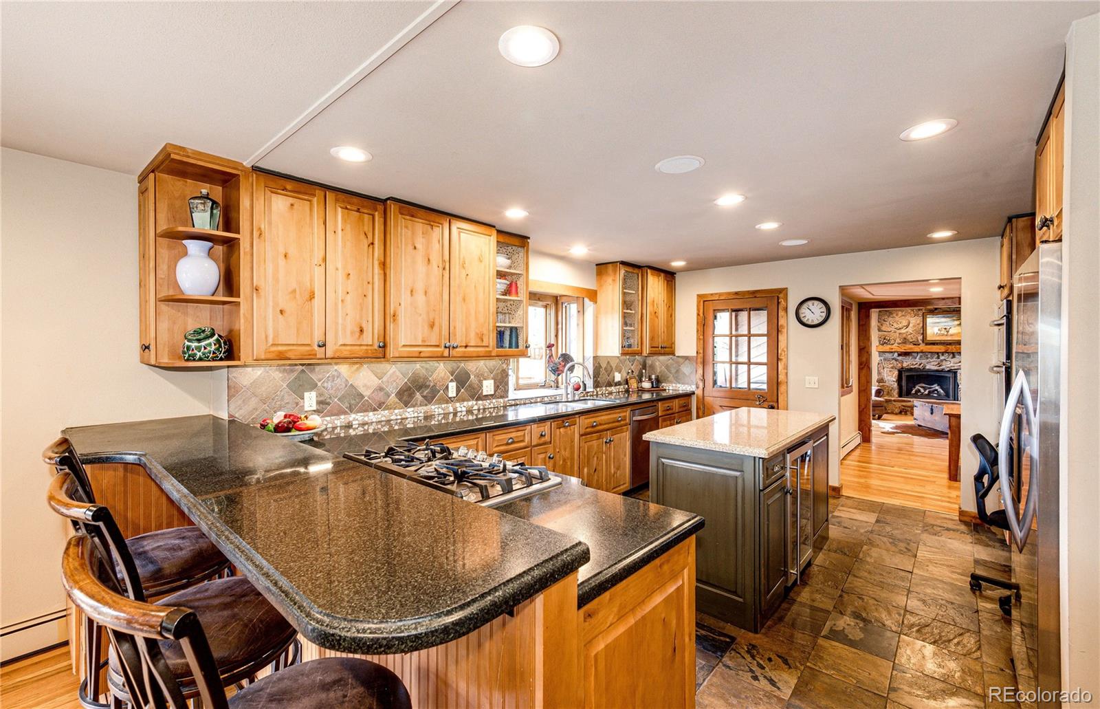 272 Greystone Road Evergreen, CO 80439 - Photo 14 of 40 a kitchen with a table chairs sink and cabinets