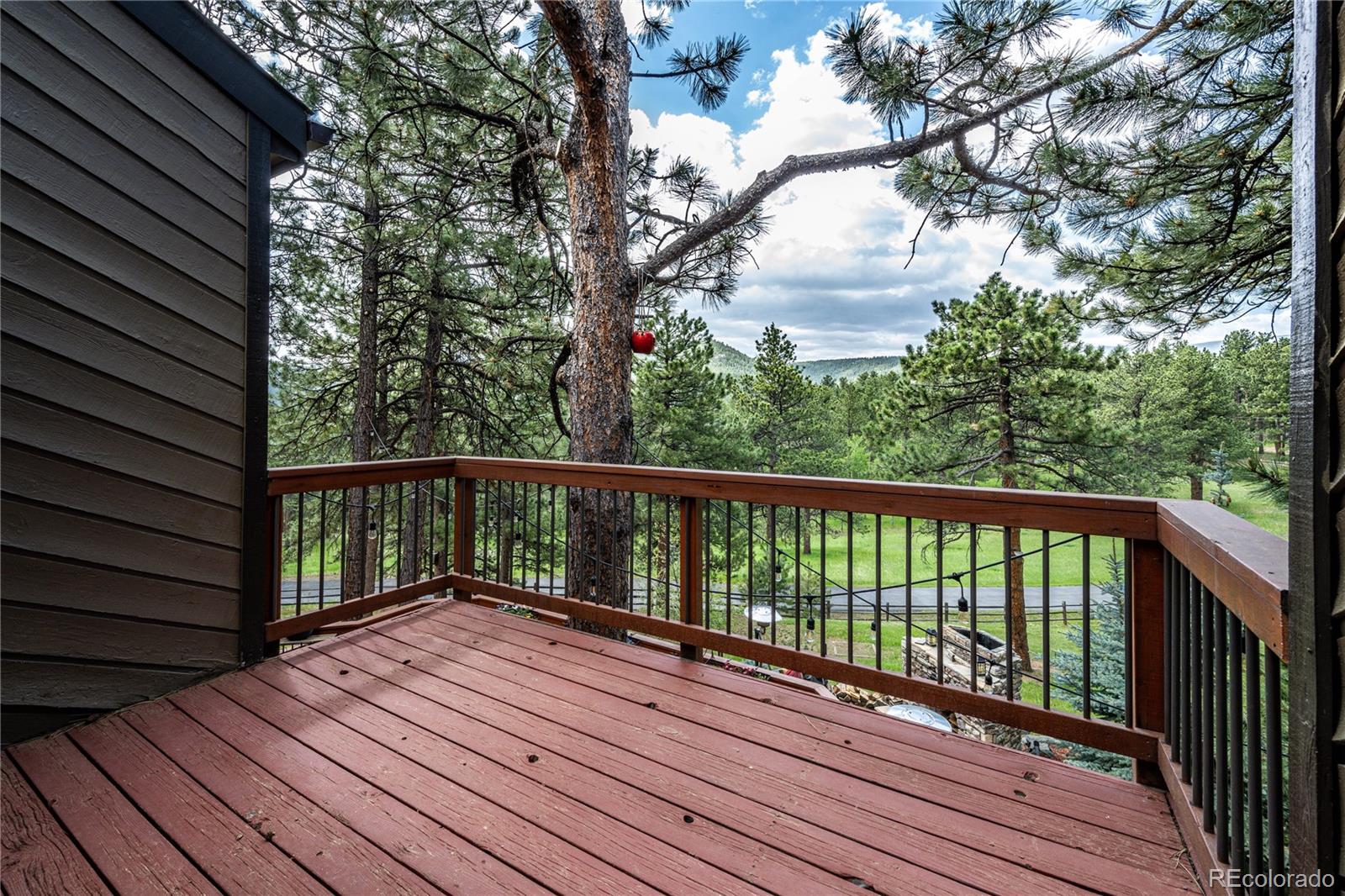 272 Greystone Road Evergreen, CO 80439 - Photo 22 of 40 a balcony with wooden floor and fence