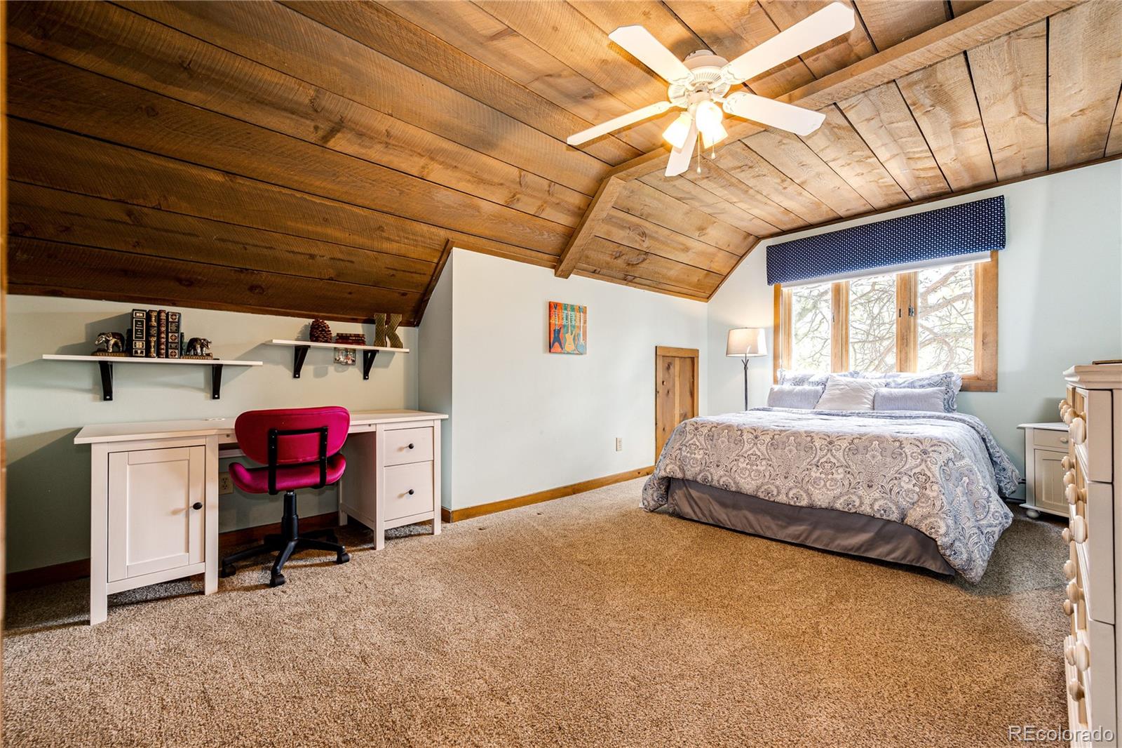 272 Greystone Road Evergreen, CO 80439 - Photo 25 of 40 a bedroom with a bed and furniture