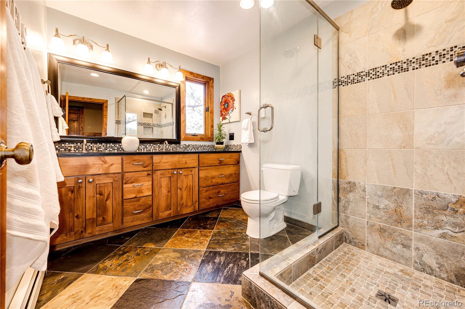 272 Greystone Road Evergreen, CO 80439 - Photo 26 of 40 a bathroom with a toilet sink and mirror
