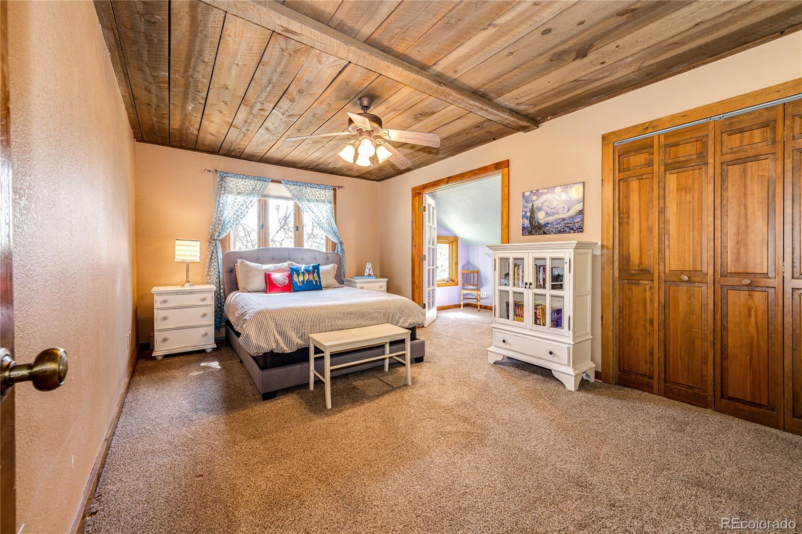 272 Greystone Road Evergreen, CO 80439 - Photo 27 of 40 a bedroom with a bed furniture and a window