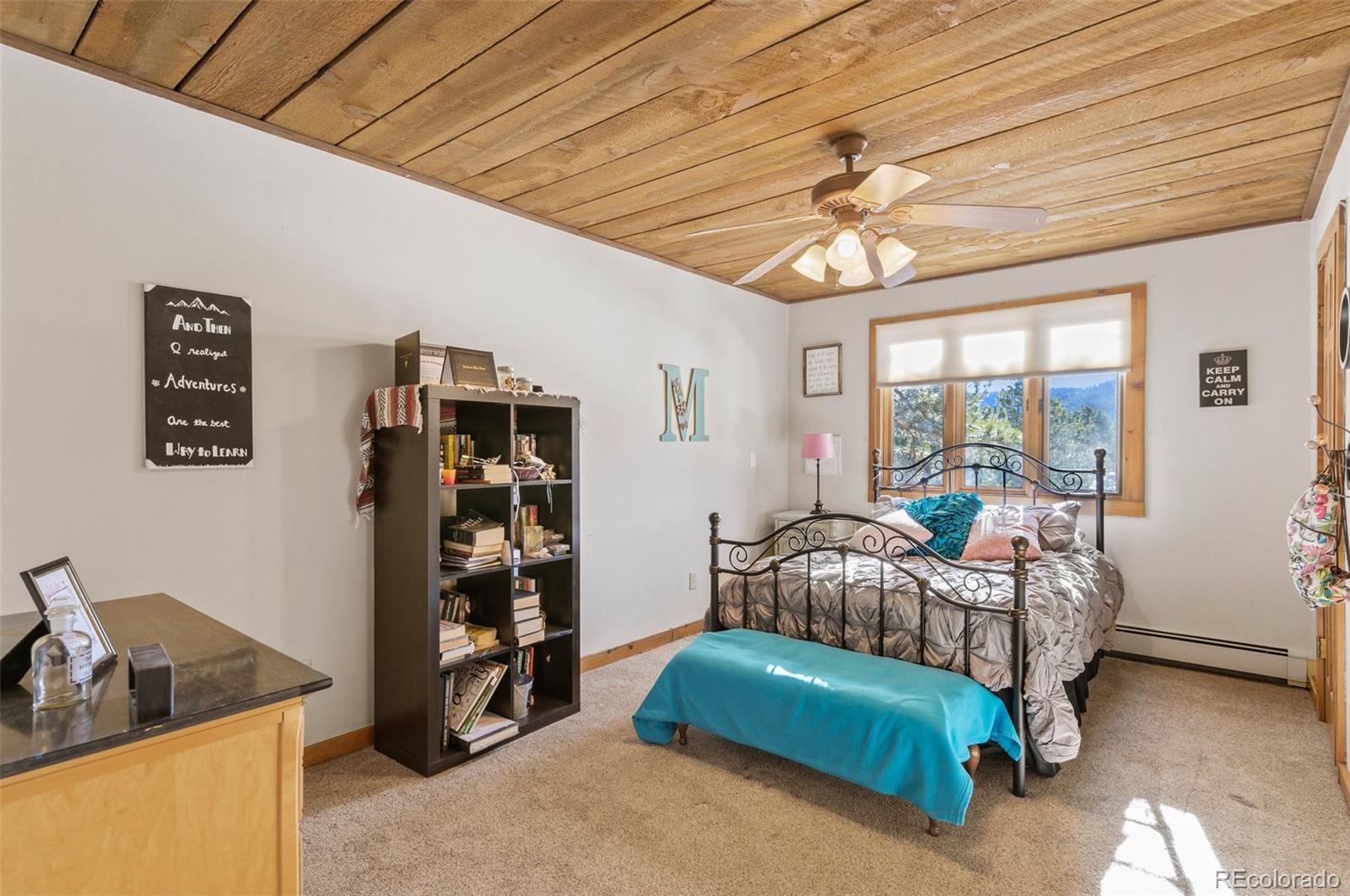 272 Greystone Road Evergreen, CO 80439 - Photo 28 of 40 a living room with furniture and a chandelier