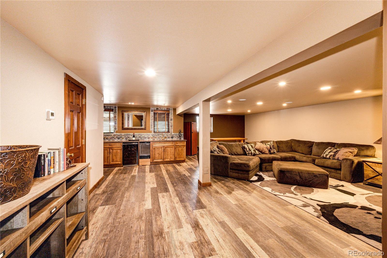 272 Greystone Road Evergreen, CO 80439 - Photo 29 of 40 a living room with furniture and a wooden floor