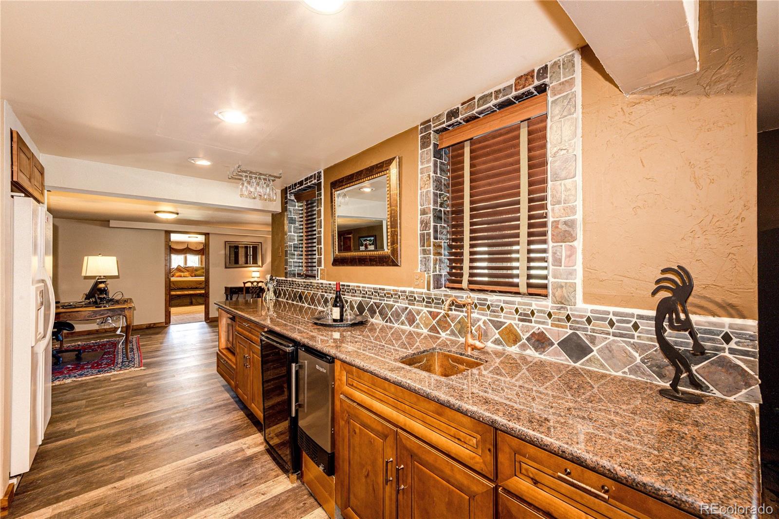 272 Greystone Road Evergreen, CO 80439 - Photo 30 of 40 a kitchen with granite countertop a sink and a stove top oven