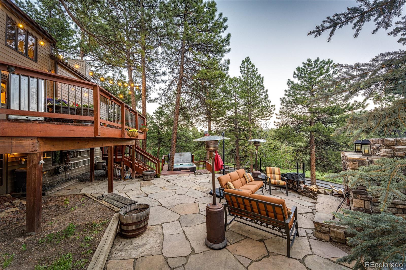 272 Greystone Road Evergreen, CO 80439 - Photo 37 of 40 an outdoor sitting area with a table and chairs