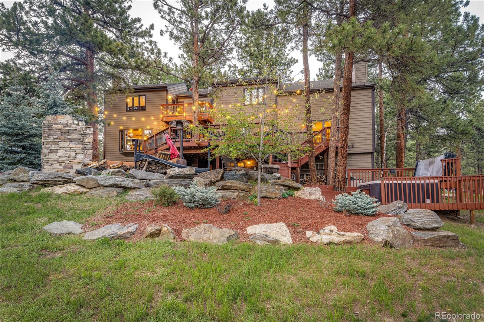 272 Greystone Road Evergreen, CO 80439 - Photo 38 of 40 a view of a chair and table in backyard