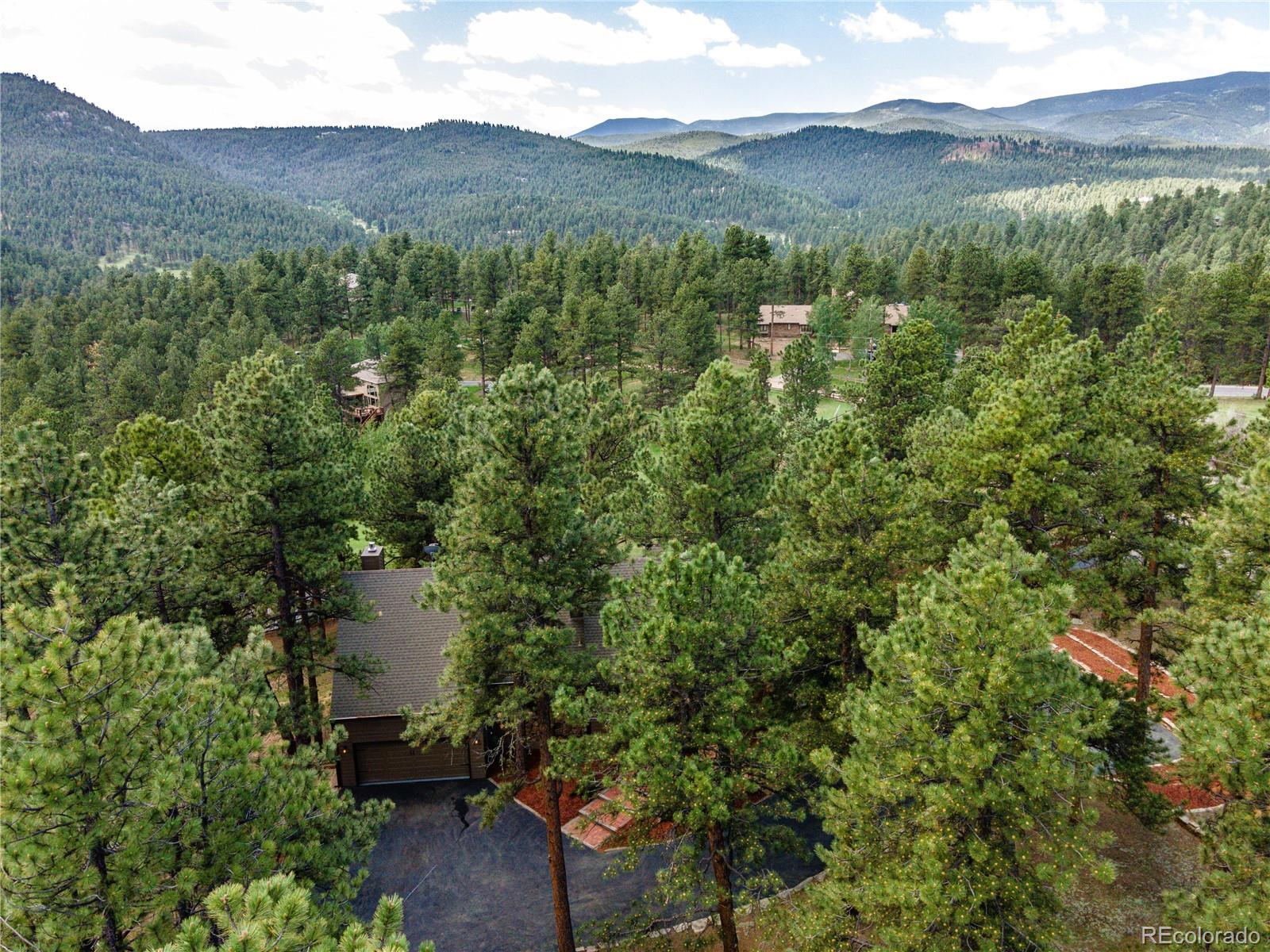272 Greystone Road Evergreen, CO 80439 - Photo 40 of 40 a view of a town with trees in the background
