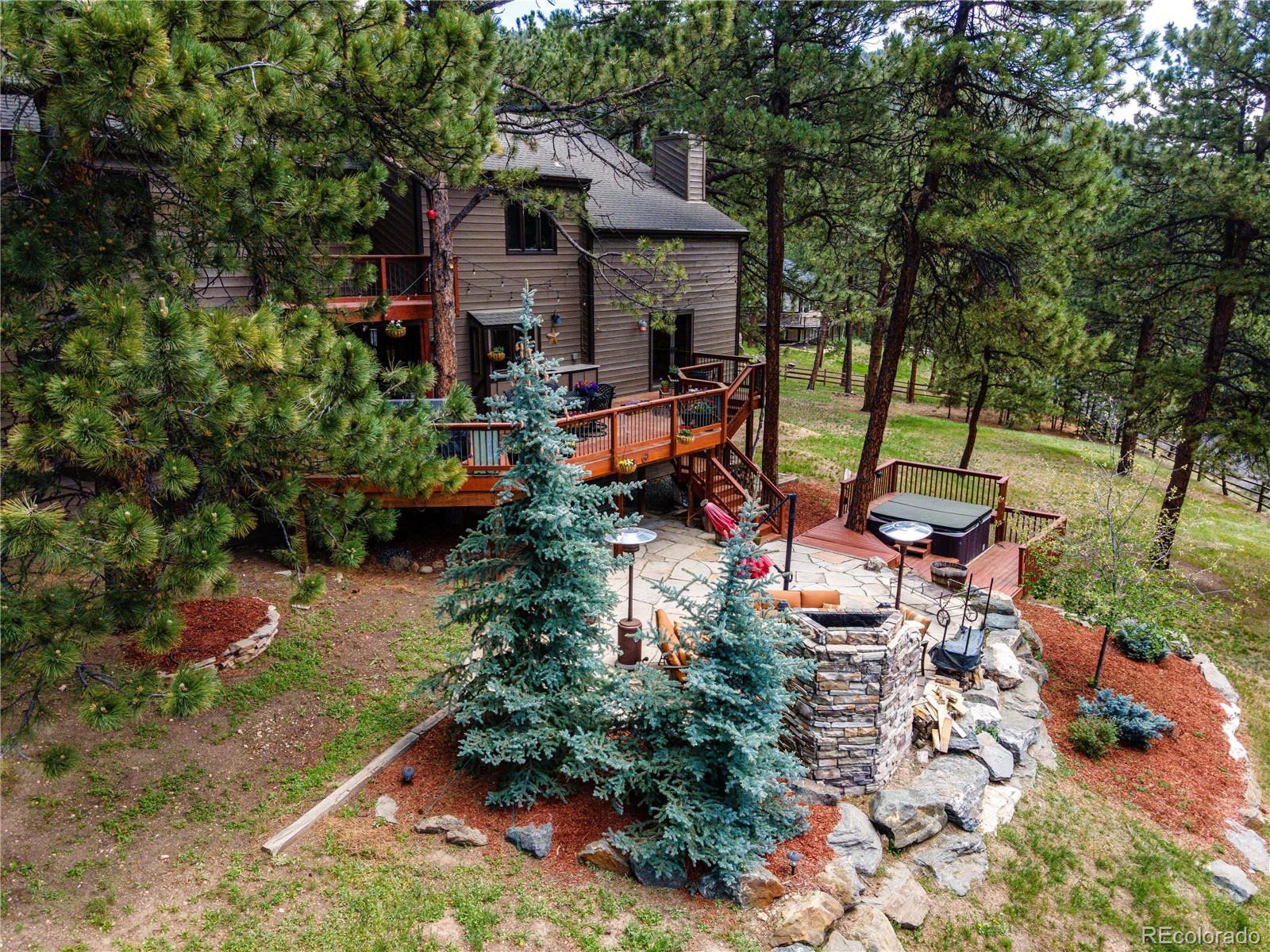 272 Greystone Road Evergreen, CO 80439 - Photo 5 of 40 an outdoor space with seating area and trees around
