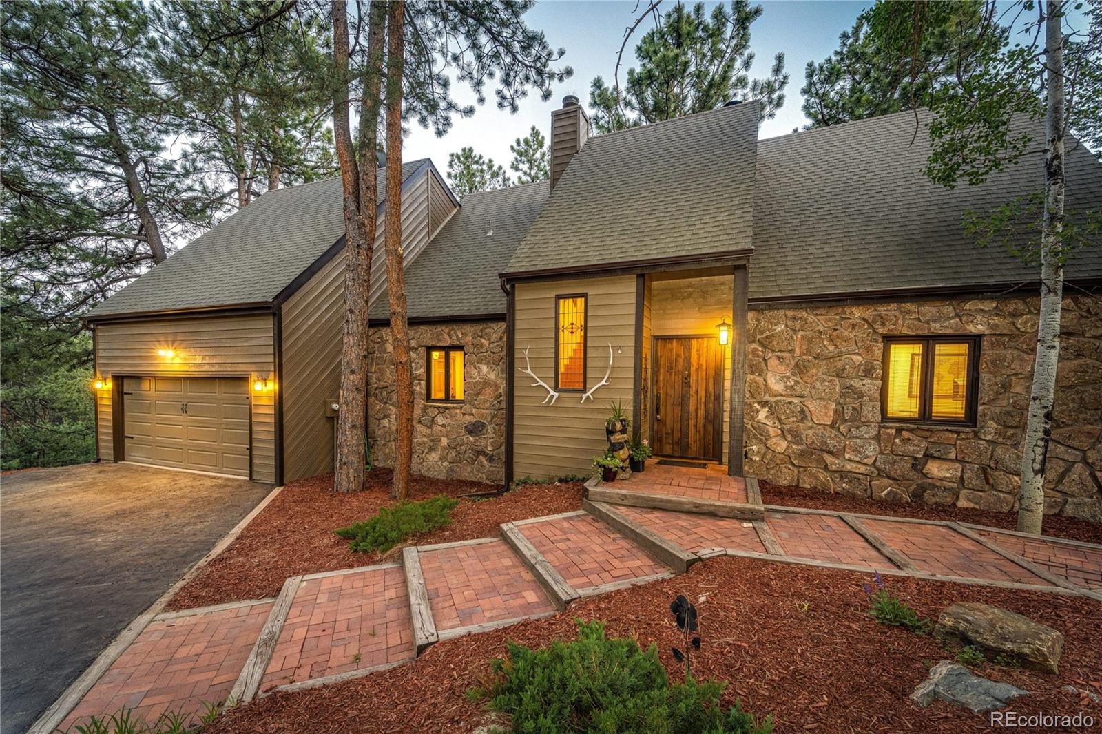 272 Greystone Road Evergreen, CO 80439 - Photo 6 of 40 a front view of a house