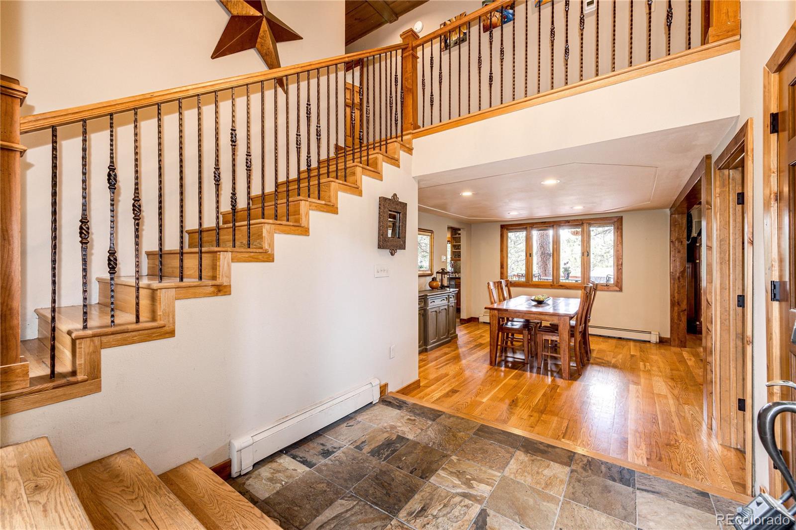 272 Greystone Road Evergreen, CO 80439 - Photo 7 of 40 a view of a dining room with furniture window and wooden floor