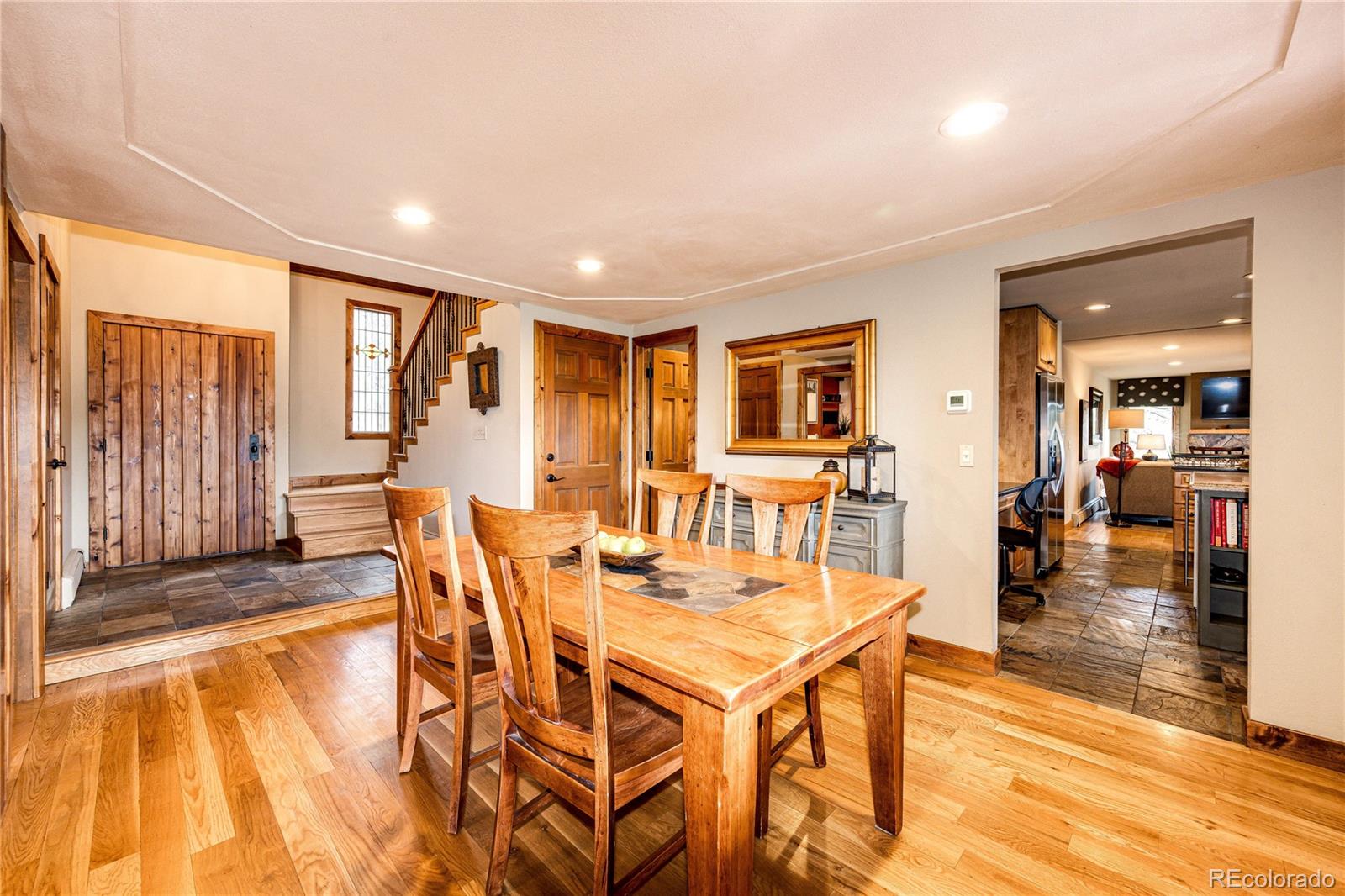 272 Greystone Road Evergreen, CO 80439 - Photo 8 of 40 a dining room with furniture and wooden floor