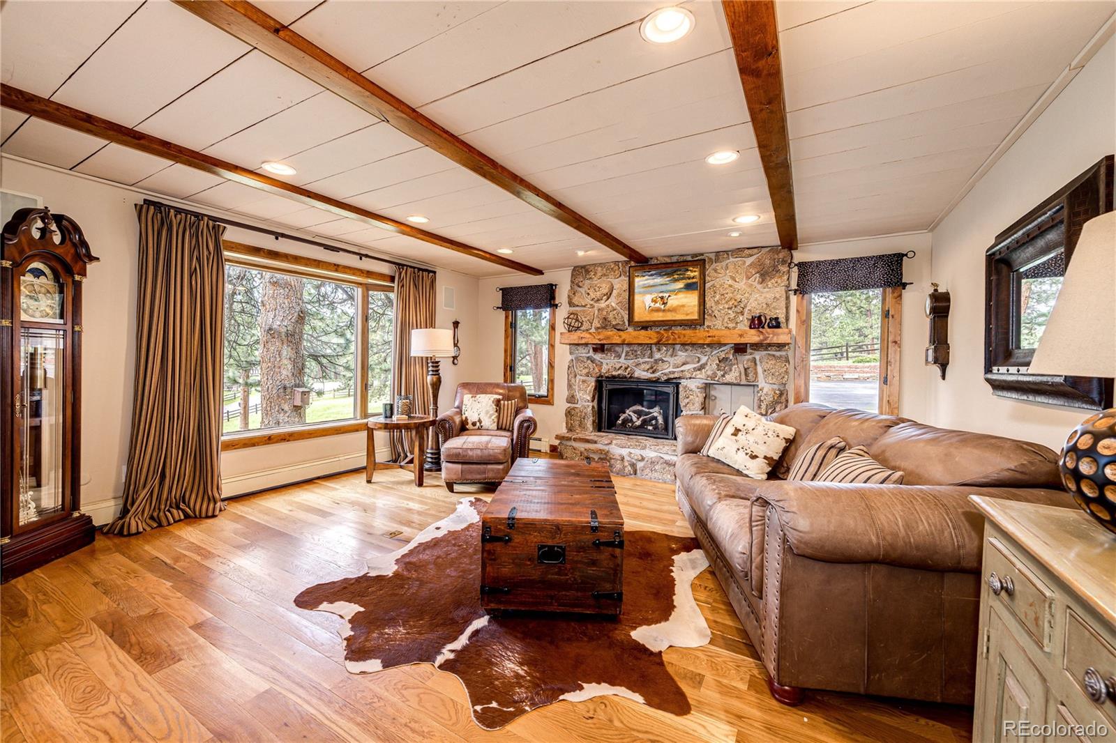272 Greystone Road Evergreen, CO 80439 - Photo 9 of 40 a living room with furniture and a fireplace