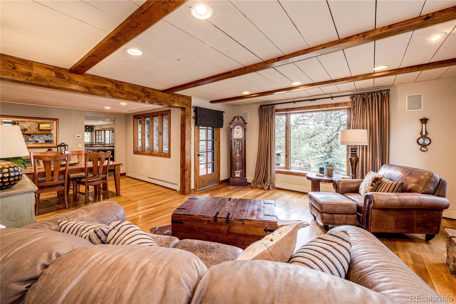 272 Greystone Road Evergreen, CO 80439 - Photo 10 of 40 a bedroom with furniture and wooden floor