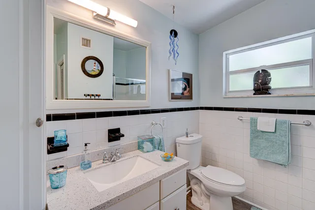 a bathroom with a toilet a sink and mirror
