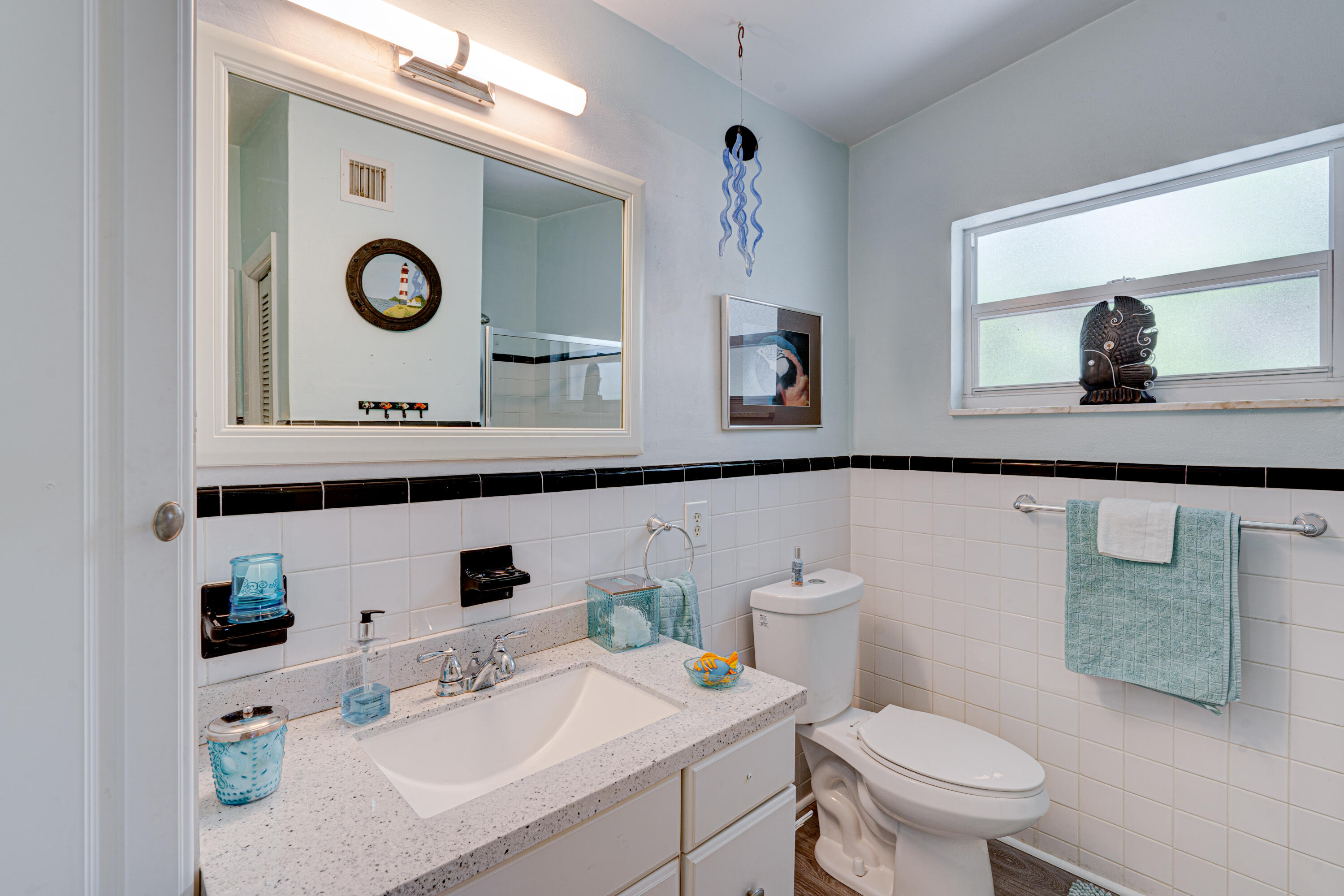 130 Plantation Avenue, Unit UPPR Tavernier, FL 33070 - Photo 14 of 34 a bathroom with a toilet a sink and mirror