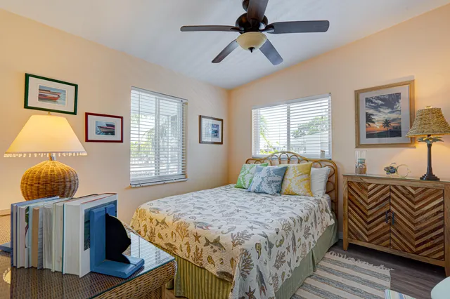 a bedroom with a bed a window and a couch