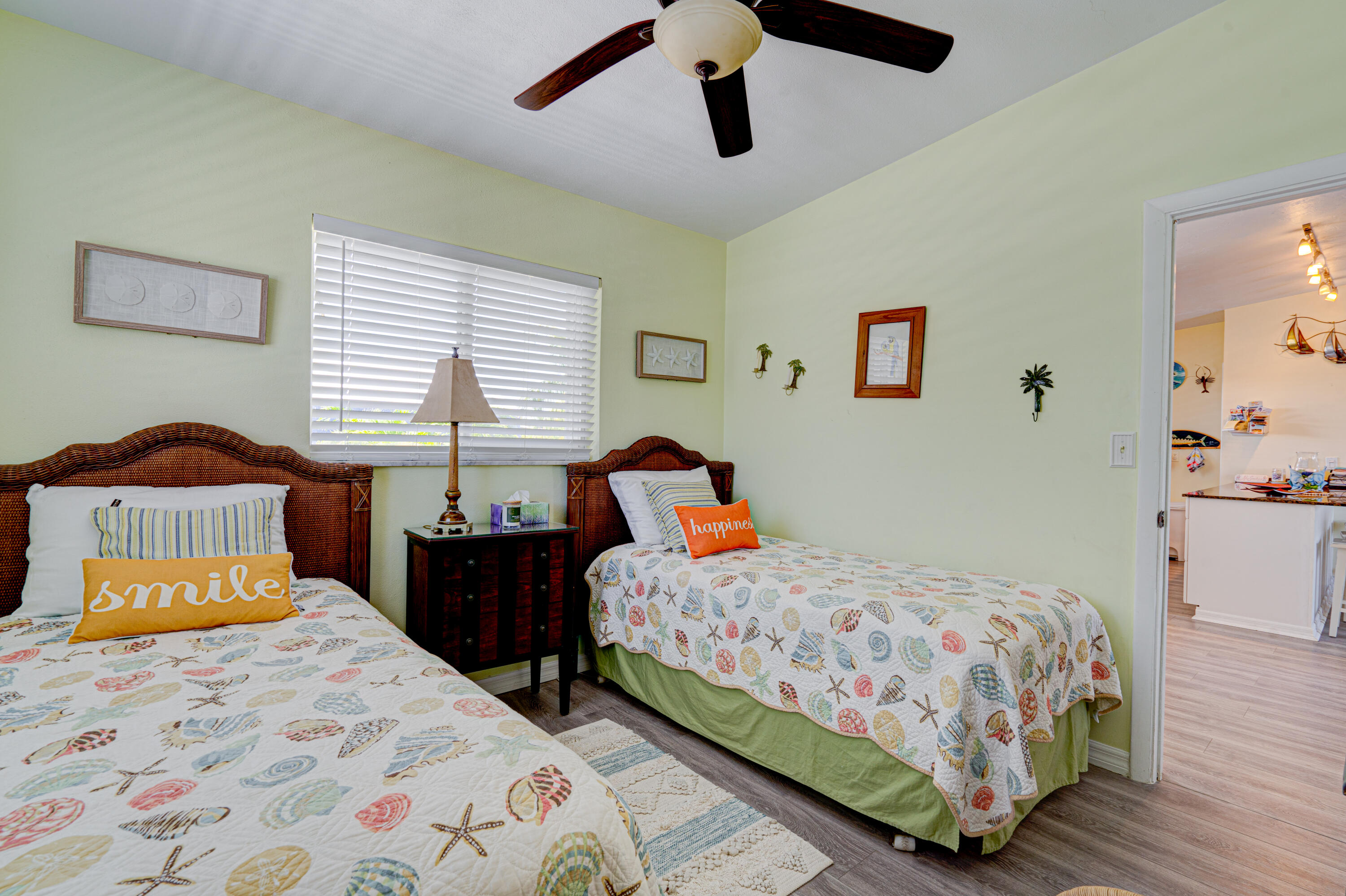 130 Plantation Avenue, Unit UPPR Tavernier, FL 33070 - Photo 17 of 34 a bedroom with a bed and wooden floor