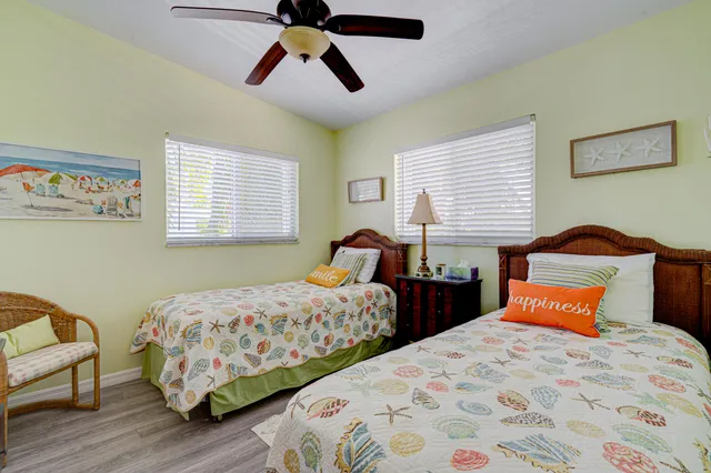 a bedroom with two beds and a chandelier