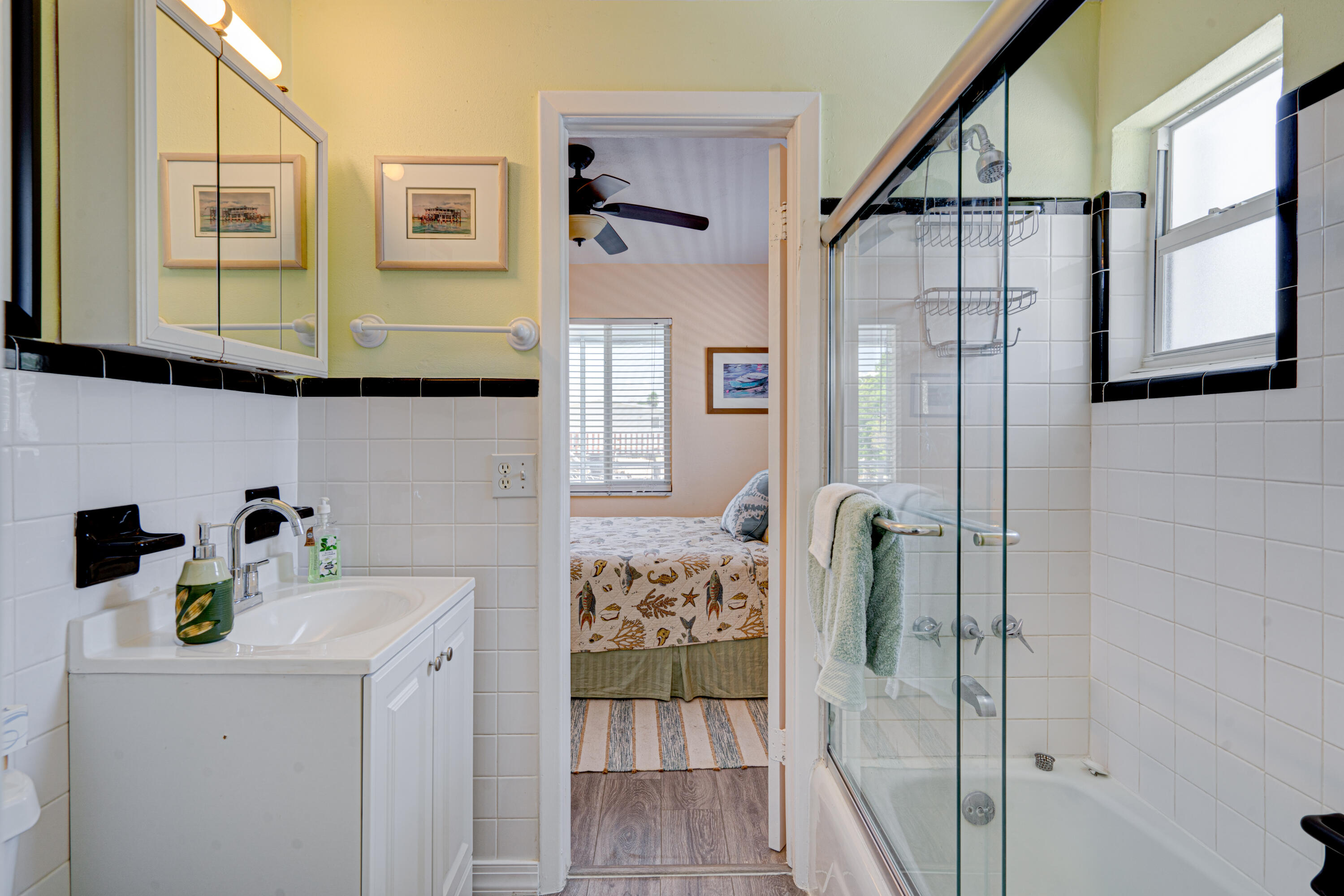 130 Plantation Avenue, Unit UPPR Tavernier, FL 33070 - Photo 20 of 34 a bathroom with a sink and a mirror