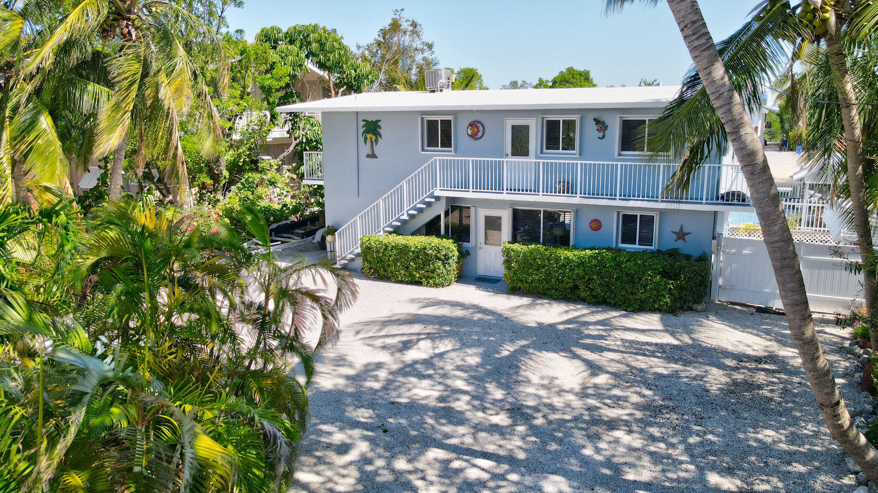 130 Plantation Avenue, Unit UPPR Tavernier, FL 33070 - Photo 22 of 34 a front view of a house with a yard