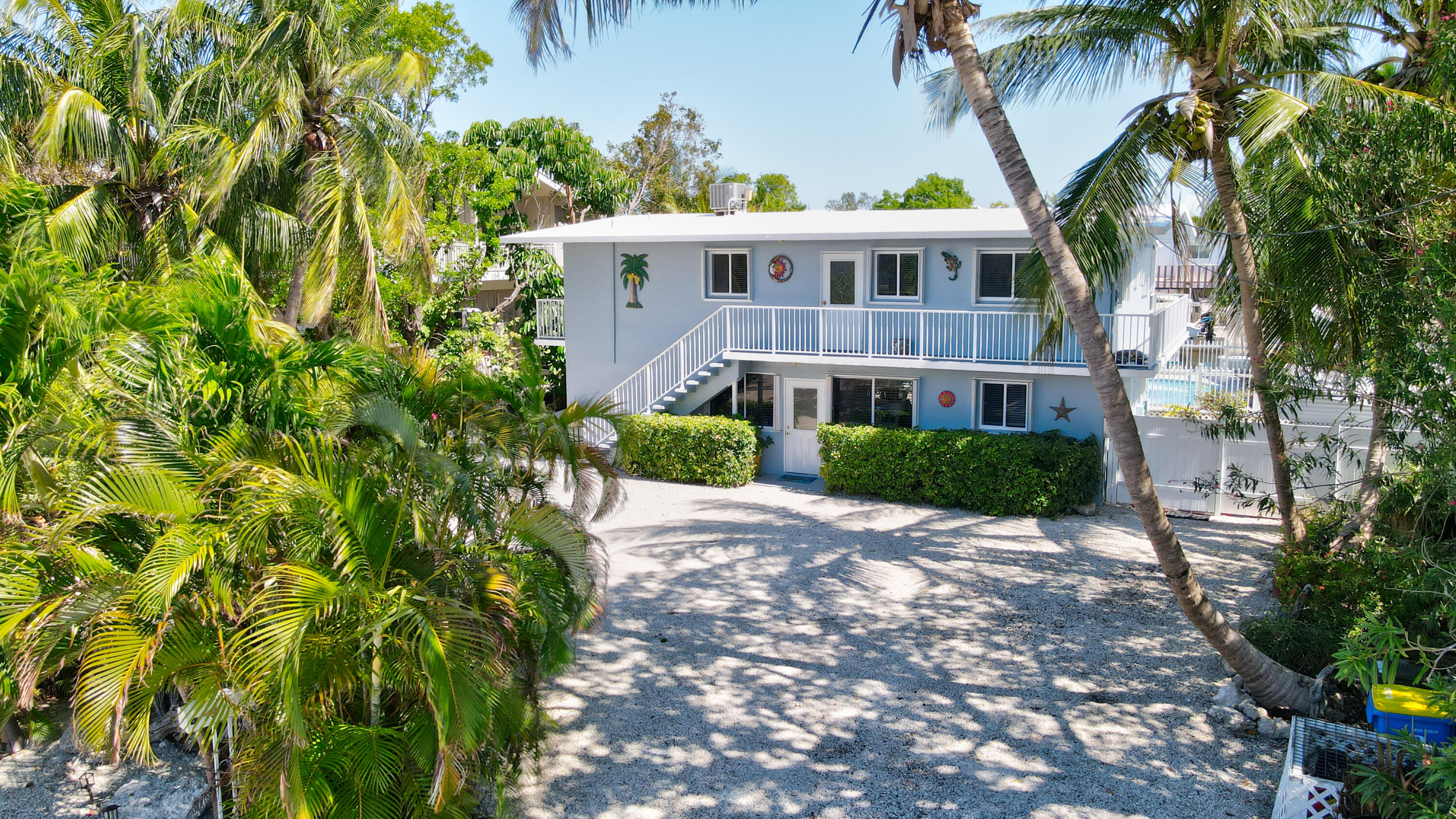 130 Plantation Avenue, Unit UPPR Tavernier, FL 33070 - Photo 23 of 34 a view of a building with a garden