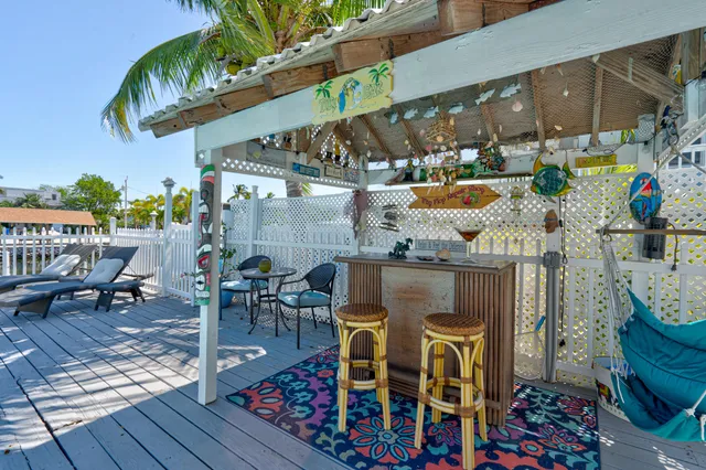 a view of a swimming pool with a patio and a yard
