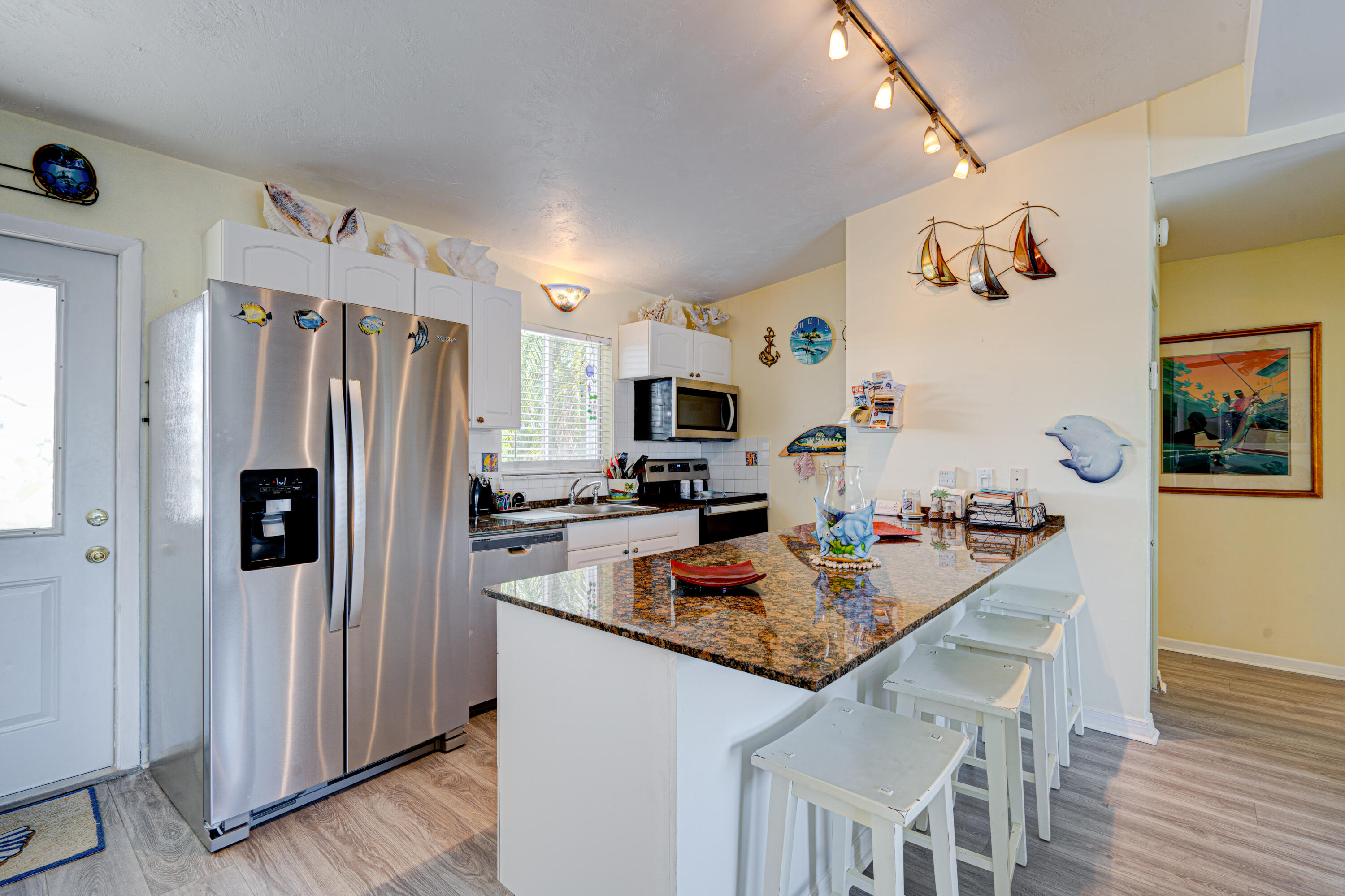 130 Plantation Avenue, Unit UPPR Tavernier, FL 33070 - Photo 3 of 34 a kitchen with stainless steel appliances granite countertop a refrigerator and a stove top oven