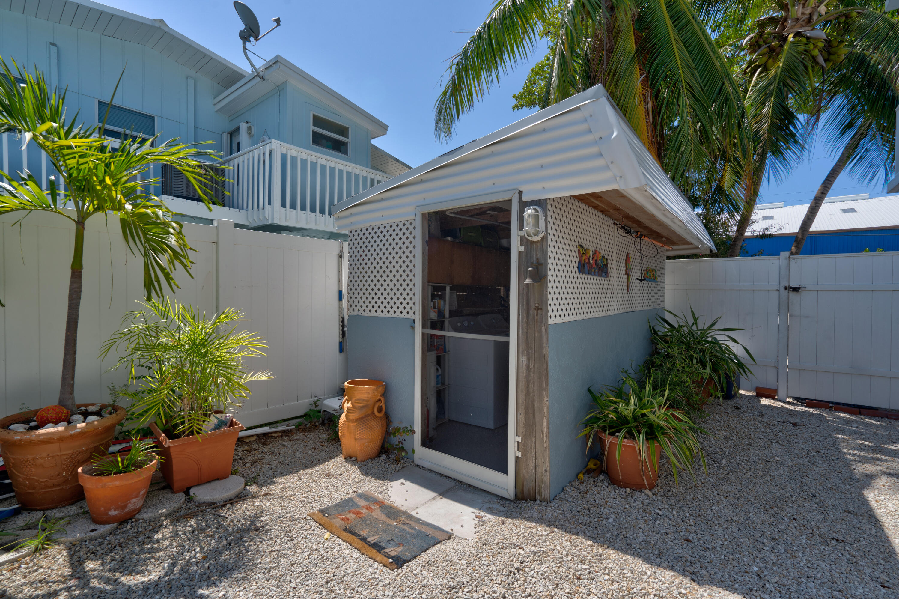 130 Plantation Avenue, Unit UPPR Tavernier, FL 33070 - Photo 32 of 34 a potted plant sitting in front of a house