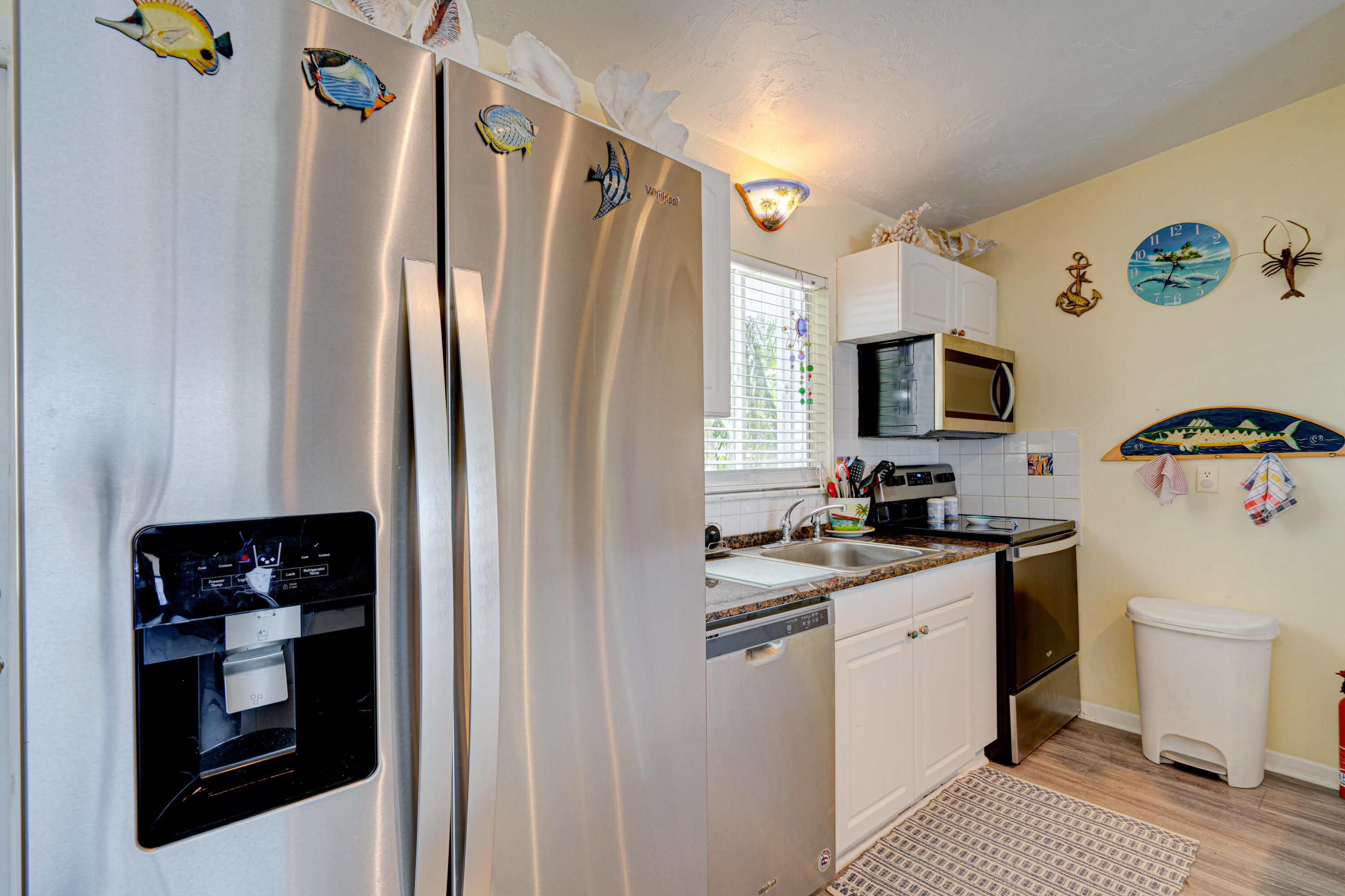 130 Plantation Avenue, Unit UPPR Tavernier, FL 33070 - Photo 5 of 34 a kitchen with a refrigerator a microwave a stove and cabinets