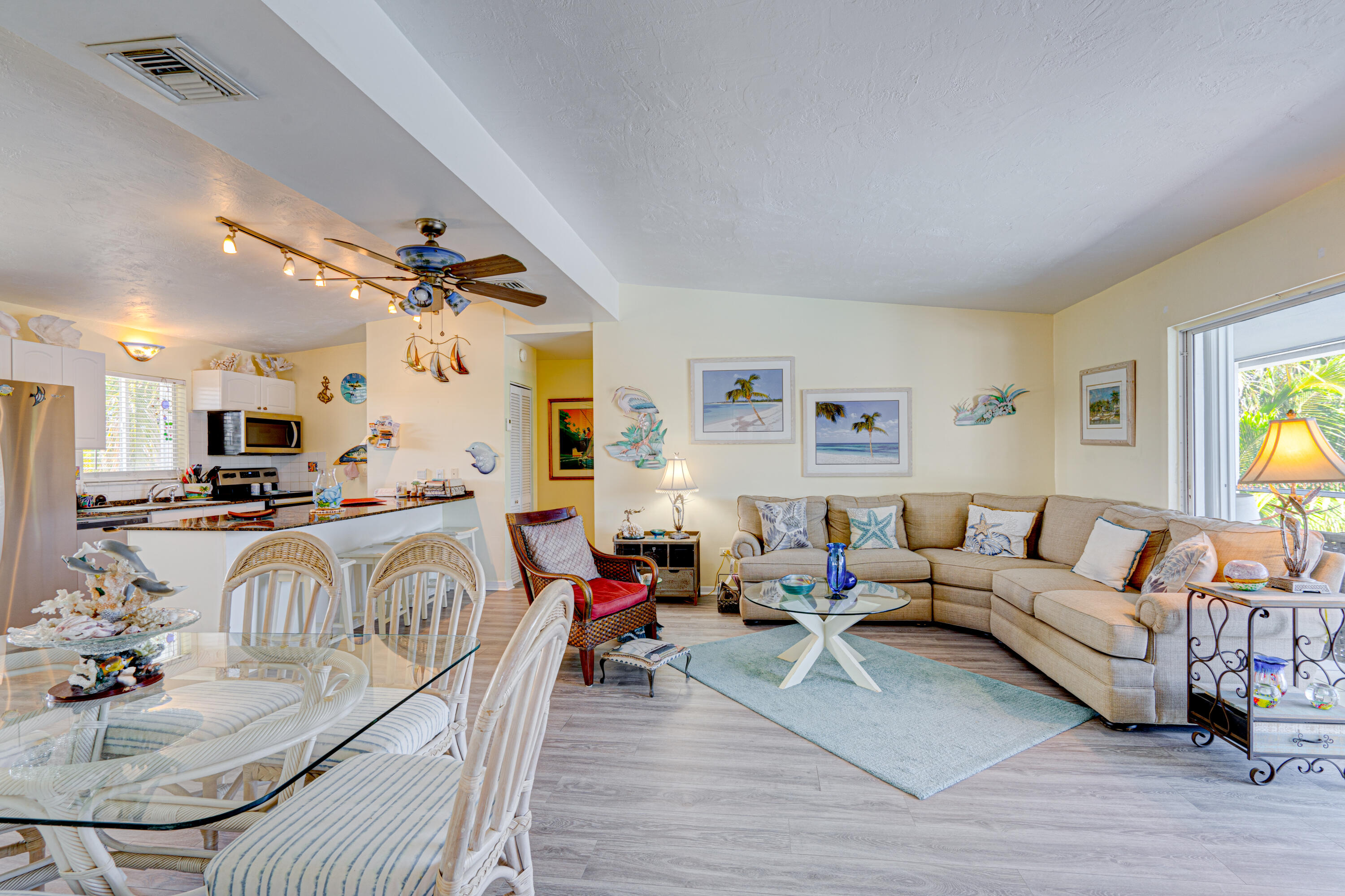 130 Plantation Avenue, Unit UPPR Tavernier, FL 33070 - Photo 8 of 34 a living room with furniture kitchen view and a wooden floor