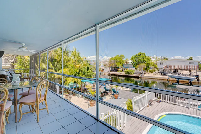 a city view from a balcony with chairs