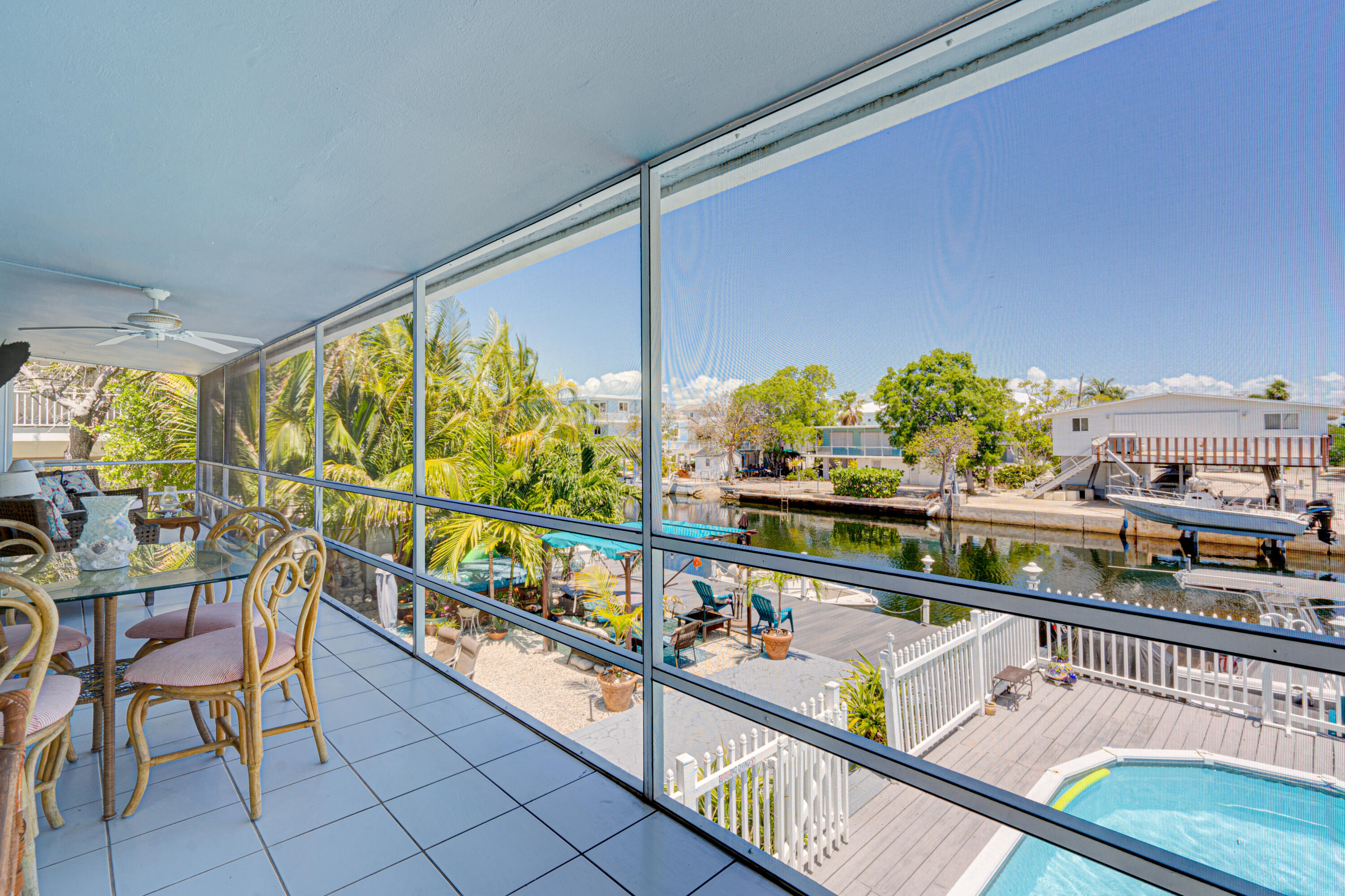 130 Plantation Avenue, Unit UPPR Tavernier, FL 33070 - Photo 9 of 34 a city view from a balcony with chairs