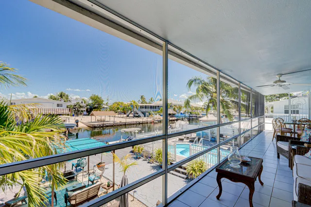 a city view from a balcony with furniture
