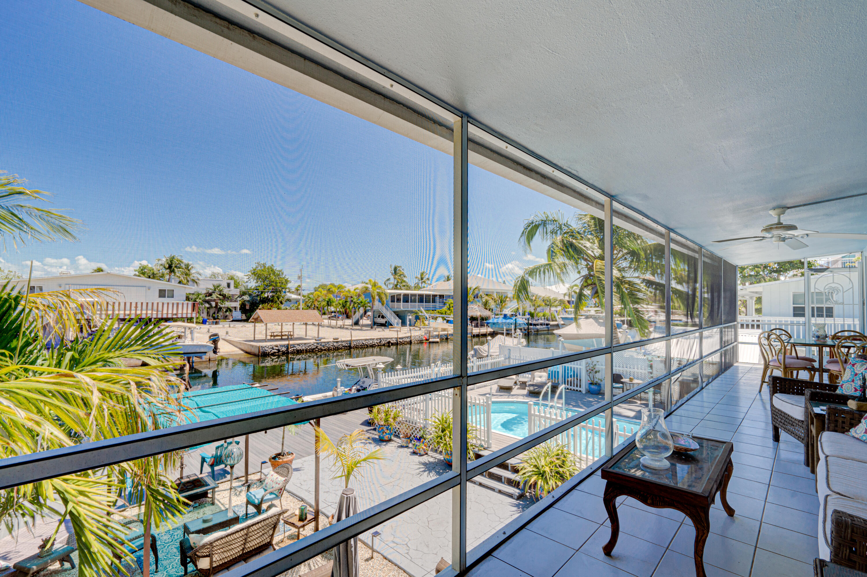 130 Plantation Avenue, Unit UPPR Tavernier, FL 33070 - Photo 10 of 34 a city view from a balcony with furniture