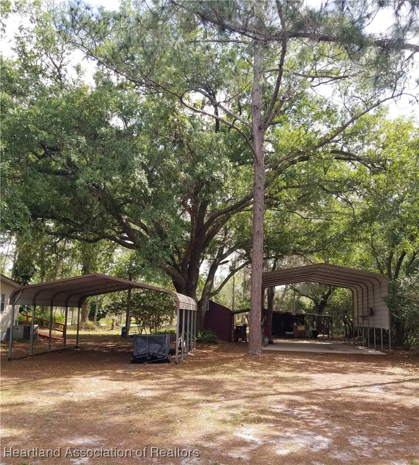 9125 Spur Path Sebring, FL 33875 - Photo 24 of 31 2-car carport & lg motorhome carport (when empty)