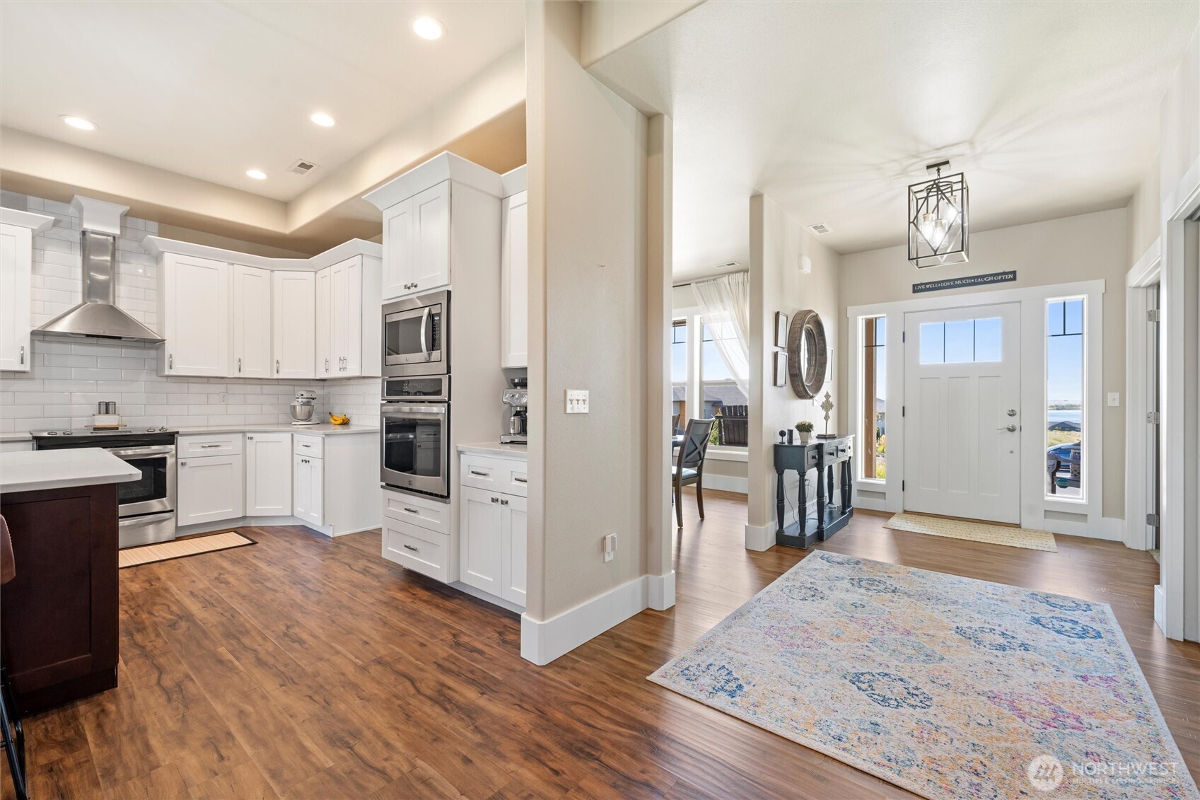 8125 Dune Lake Road Southeast Moses Lake, WA 98837 - Photo 11 of 40 a open kitchen with white cabinets and stainless steel appliances