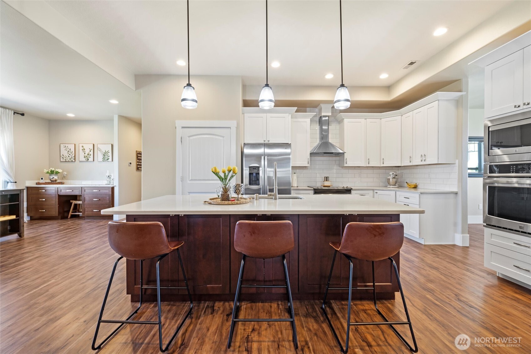 8125 Dune Lake Road Southeast Moses Lake, WA 98837 - Photo 12 of 40 a kitchen with stainless steel appliances a dining table chairs refrigerator and sink