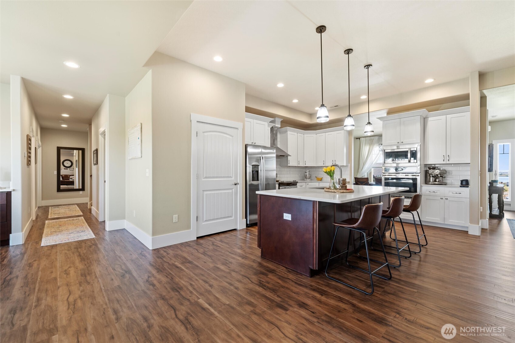 8125 Dune Lake Road Southeast Moses Lake, WA 98837 - Photo 13 of 40 a open kitchen with stainless steel appliances granite countertop a refrigerator a oven a stove and a wooden floors
