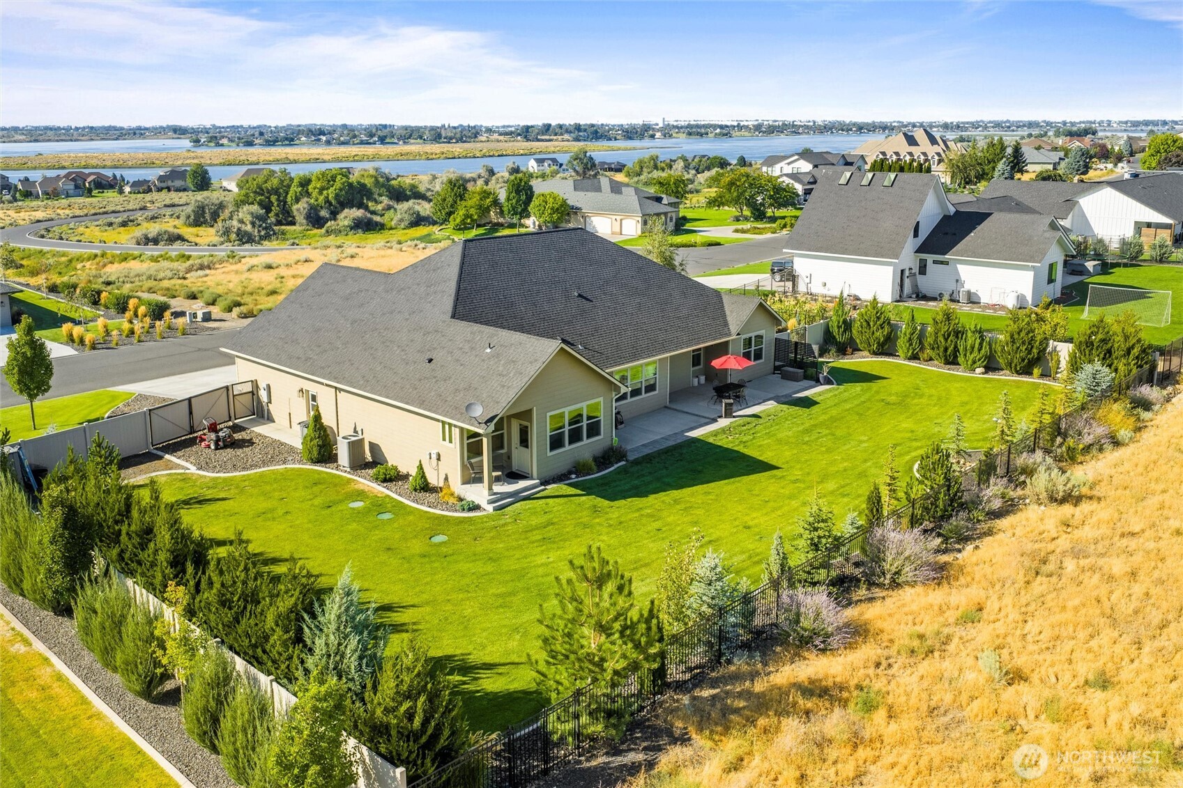 8125 Dune Lake Road Southeast Moses Lake, WA 98837 - Photo 2 of 40 an aerial view of residential houses with outdoor space and swimming pool