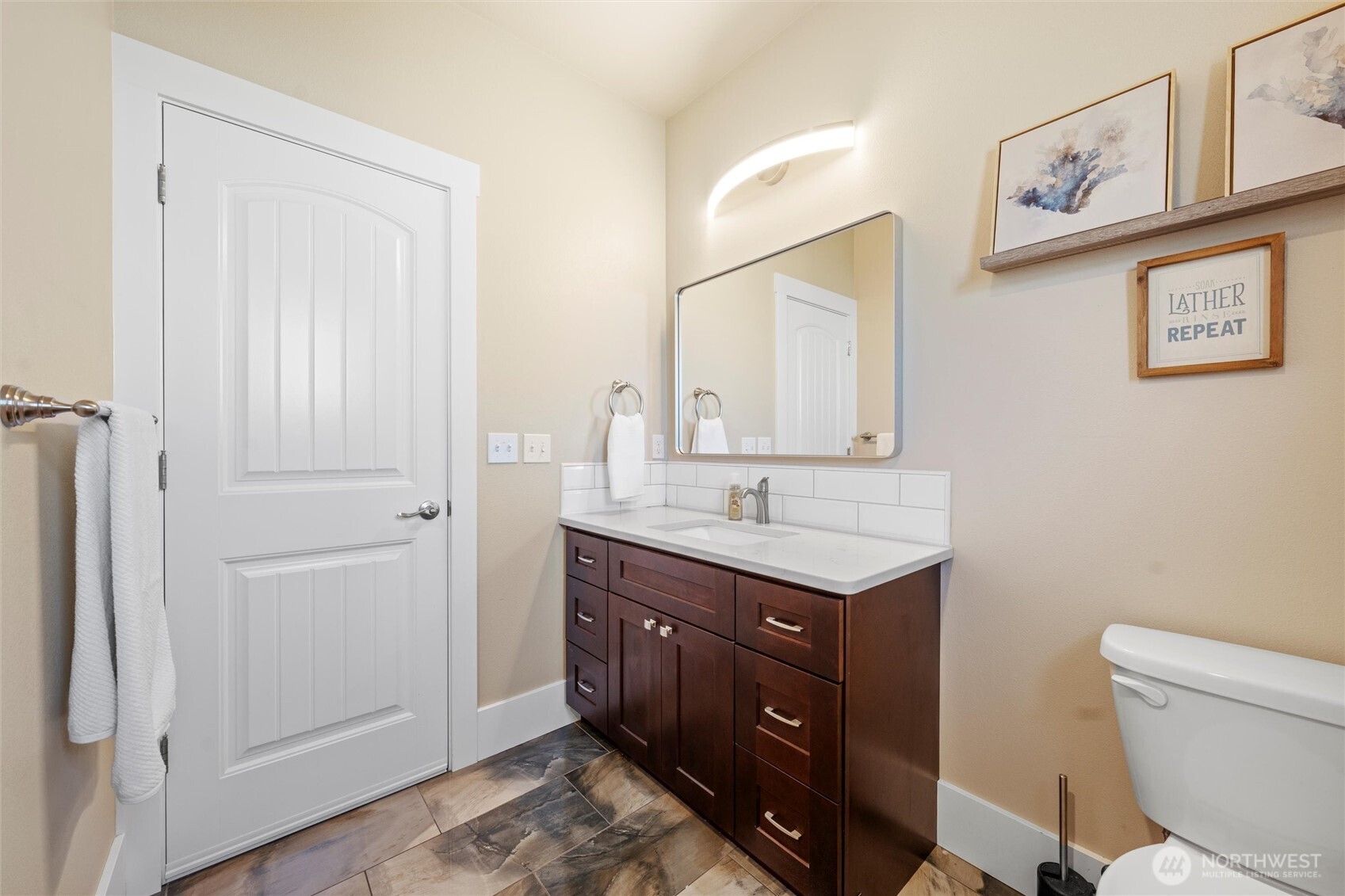 8125 Dune Lake Road Southeast Moses Lake, WA 98837 - Photo 21 of 40 a bathroom with a toilet a sink a vanity and mirror