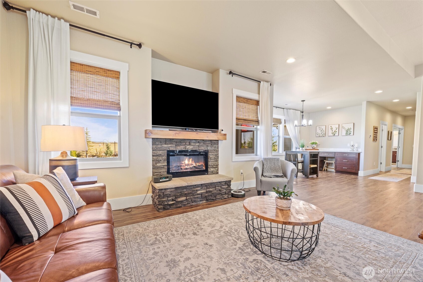 8125 Dune Lake Road Southeast Moses Lake, WA 98837 - Photo 23 of 40 a living room with furniture a fireplace and a flat screen tv