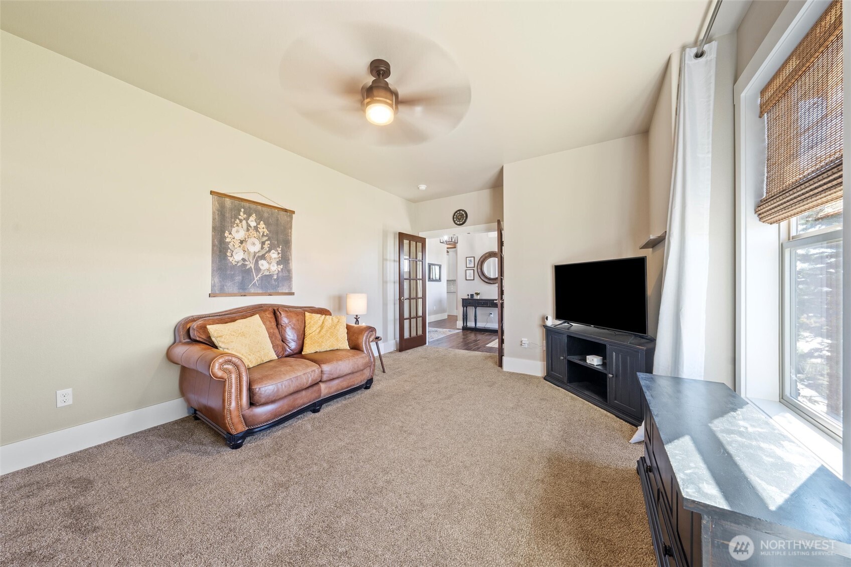 8125 Dune Lake Road Southeast Moses Lake, WA 98837 - Photo 24 of 40 a living room with furniture and a flat screen tv