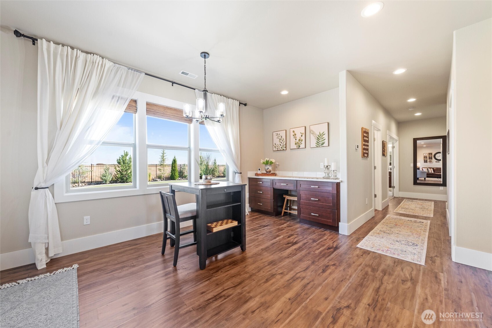 8125 Dune Lake Road Southeast Moses Lake, WA 98837 - Photo 26 of 40 a kitchen with stainless steel appliances a table chairs refrigerator and sink