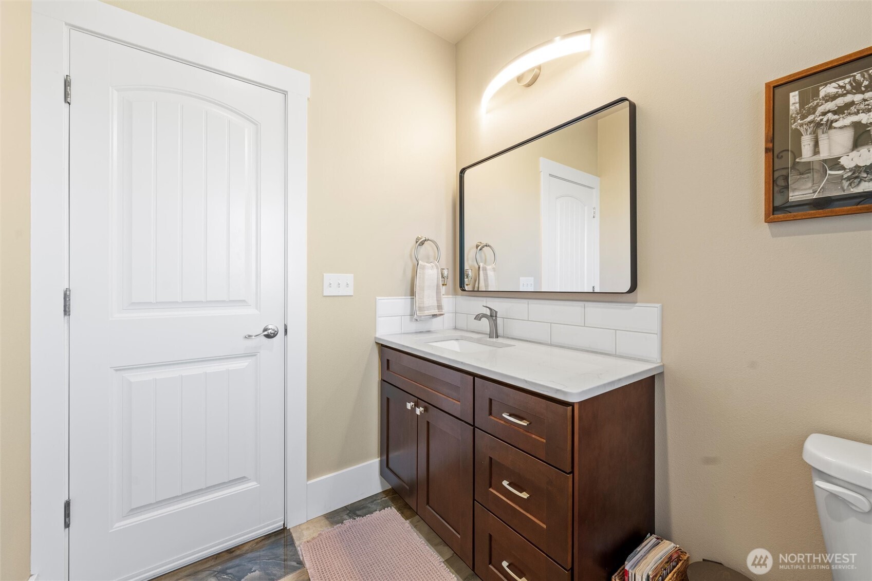 8125 Dune Lake Road Southeast Moses Lake, WA 98837 - Photo 28 of 40 a bathroom with a toilet a sink a vanity and mirror