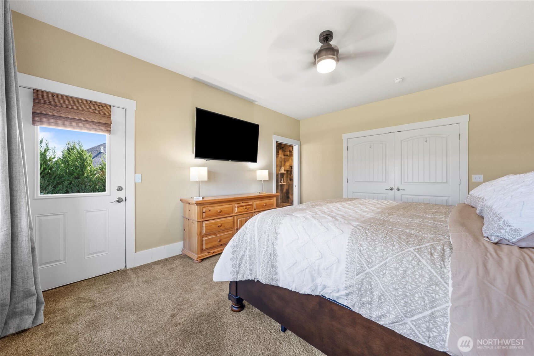 8125 Dune Lake Road Southeast Moses Lake, WA 98837 - Photo 31 of 40 a bedroom with a bed and a flat screen tv