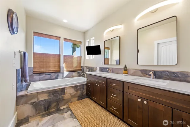 a spacious bathroom with a double vanity sink mirror and double