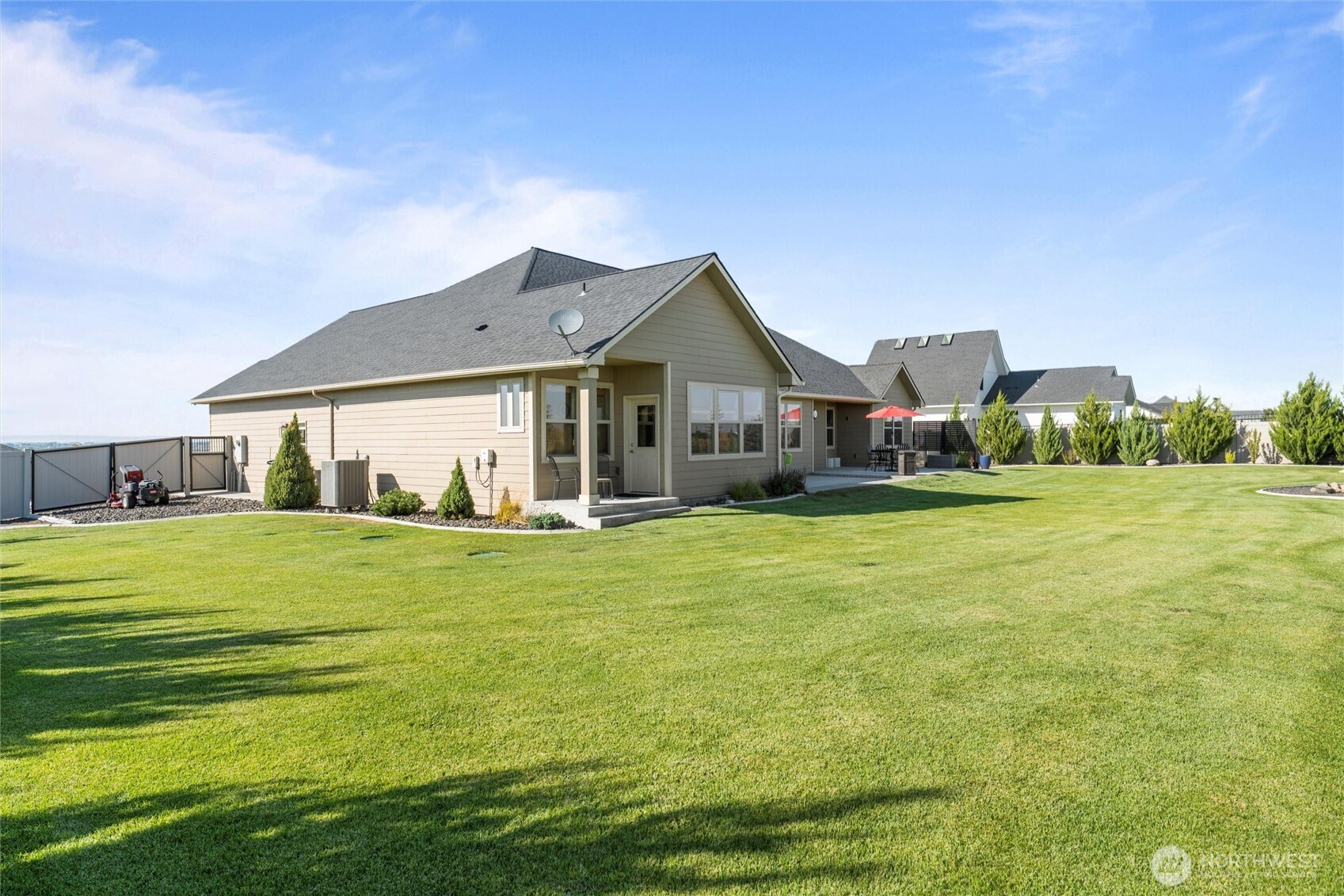 8125 Dune Lake Road Southeast Moses Lake, WA 98837 - Photo 40 of 40 a front view of a house with a garden and yard