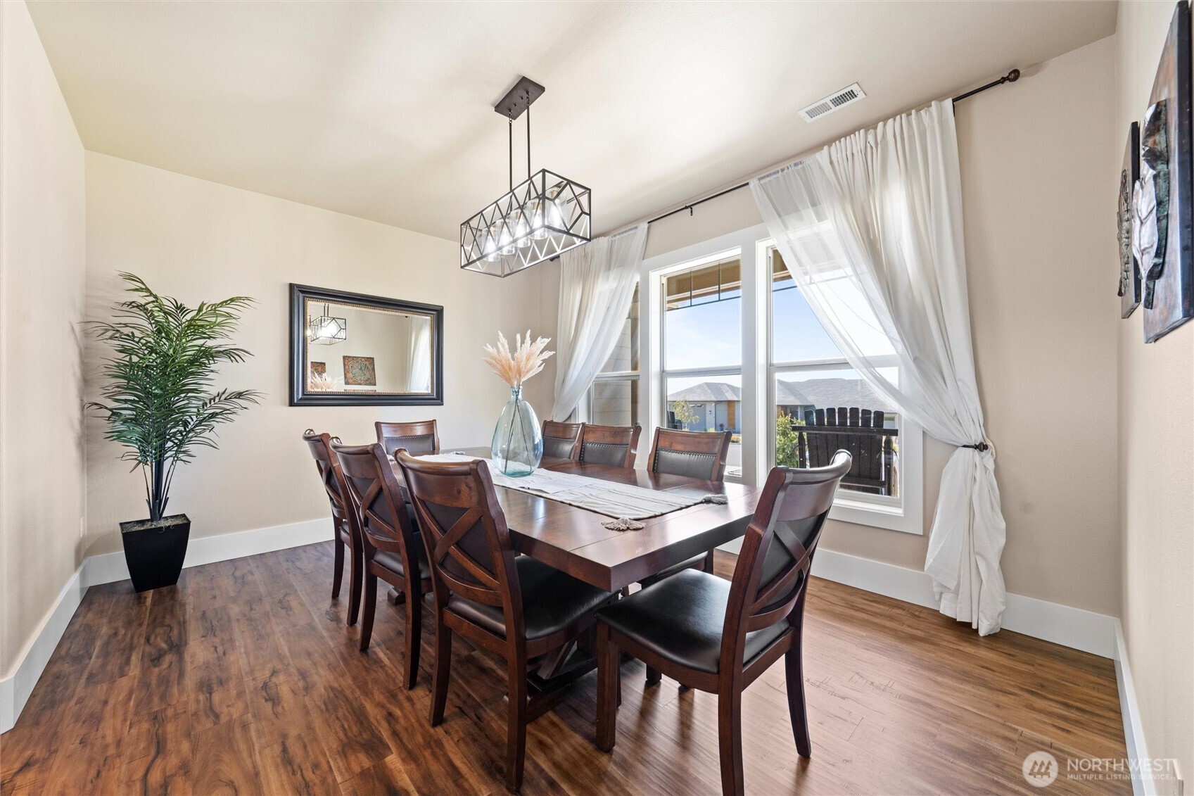 8125 Dune Lake Road Southeast Moses Lake, WA 98837 - Photo 7 of 40 a view of a dining room with furniture window and wooden floor