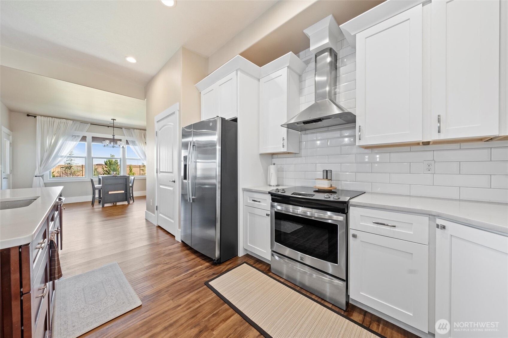 8125 Dune Lake Road Southeast Moses Lake, WA 98837 - Photo 9 of 40 a kitchen with stainless steel appliances a stove a refrigerator and cabinets