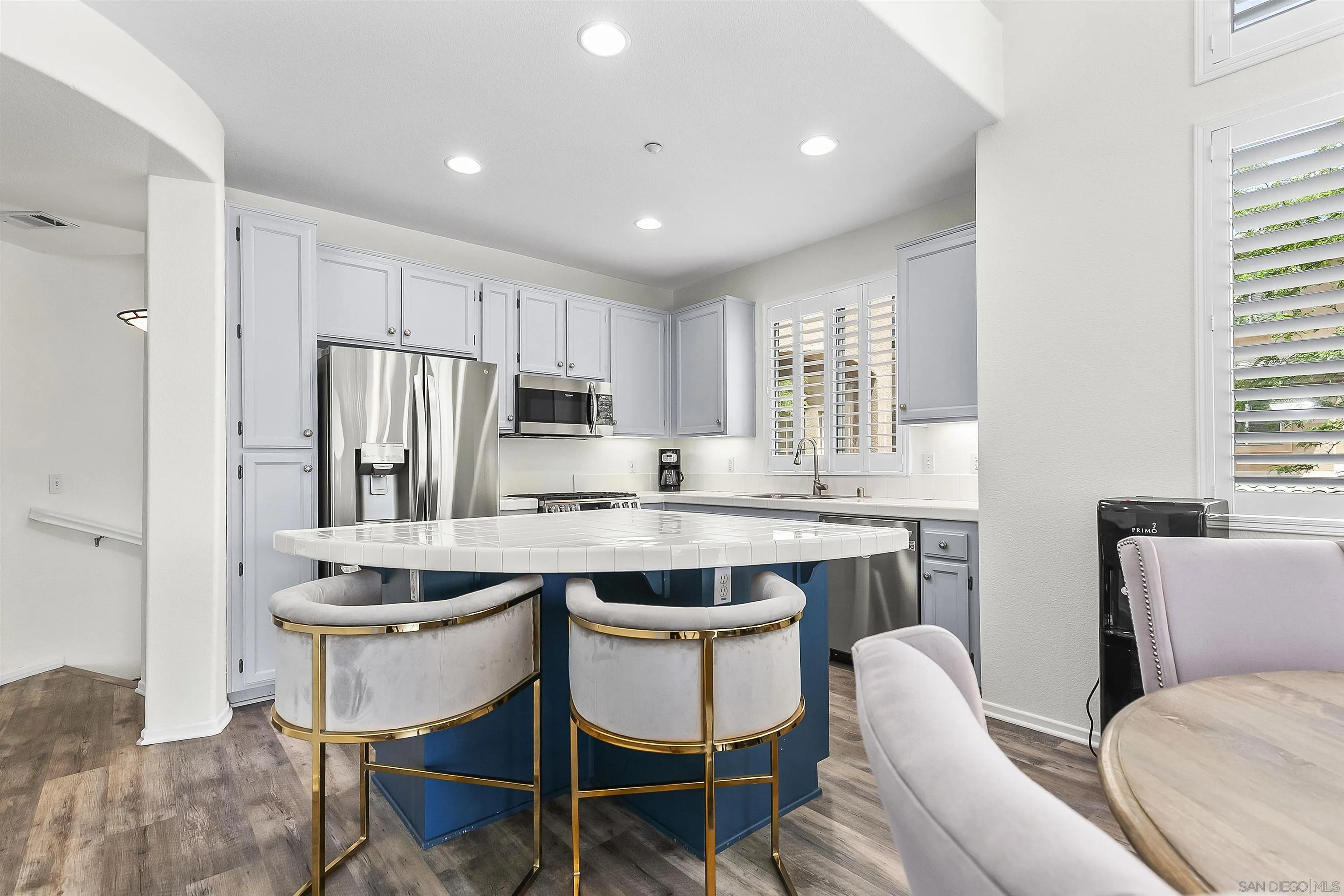 3177 Dehesa Road El Cajon, CA 92019 - Photo 8 of 55 a kitchen with refrigerator a stove and chairs